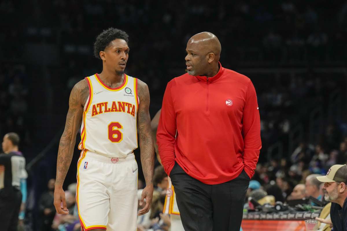 Mar 16, 2022; Charlotte, North Carolina, USA; Atlanta Hawks head coach Nate McMillan head coach Nate McMillan talks with guard Lou Williams (6) during the second quarter against the Charlotte Hornets at the Spectrum Center.